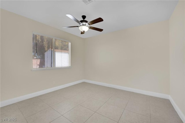 tiled spare room with ceiling fan