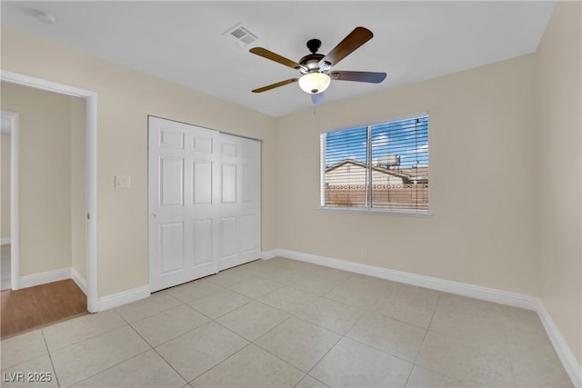 unfurnished bedroom featuring ceiling fan, a closet, and light tile patterned floors