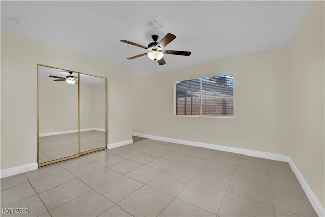 unfurnished bedroom featuring light tile patterned flooring, ceiling fan, and a closet