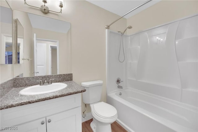 full bathroom featuring vanity, tub / shower combination, hardwood / wood-style floors, and toilet