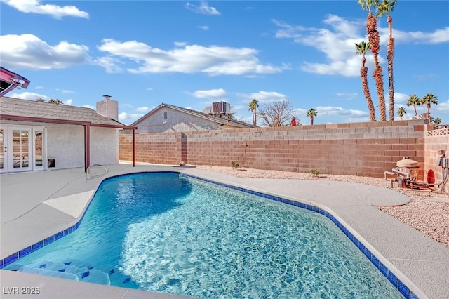 view of pool with a patio and cooling unit