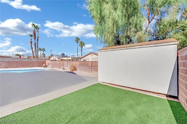 view of yard with a fenced in pool and a patio area