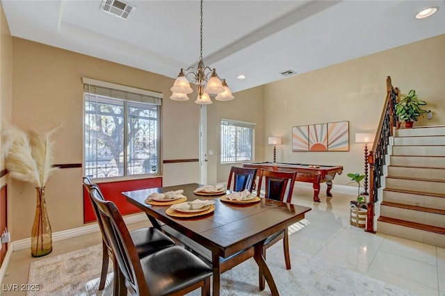 tiled dining area with pool table and a chandelier