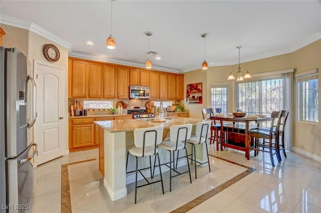 kitchen featuring light tile patterned flooring, an island with sink, a chandelier, hanging light fixtures, and stainless steel appliances