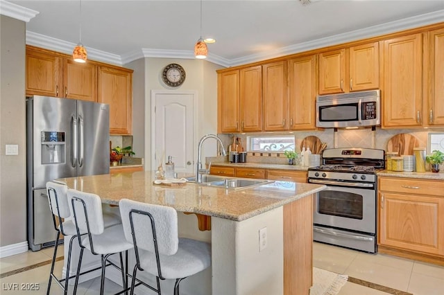 kitchen with light tile patterned flooring, decorative light fixtures, an island with sink, sink, and stainless steel appliances