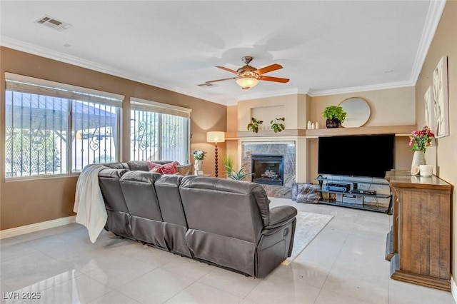 tiled living room with crown molding, ceiling fan, and a premium fireplace