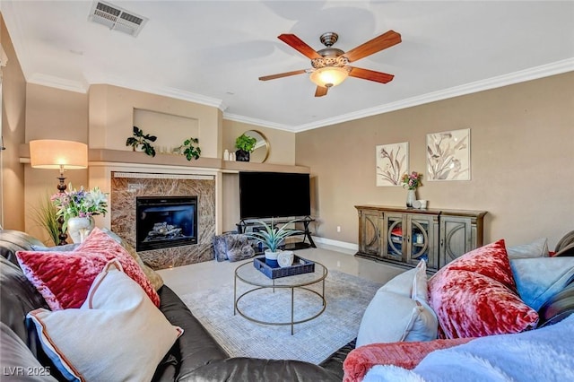 living room featuring built in shelves, ceiling fan, ornamental molding, and a fireplace