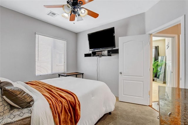 bedroom featuring light colored carpet and ceiling fan