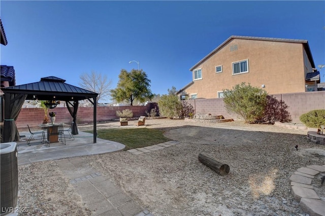 view of yard with a gazebo, central AC unit, and a patio area