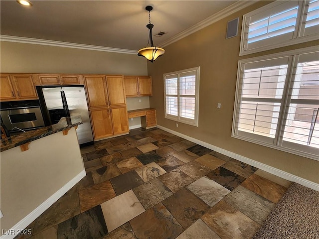 kitchen featuring appliances with stainless steel finishes, built in desk, ornamental molding, and hanging light fixtures