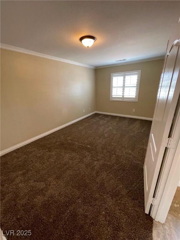 carpeted spare room with crown molding