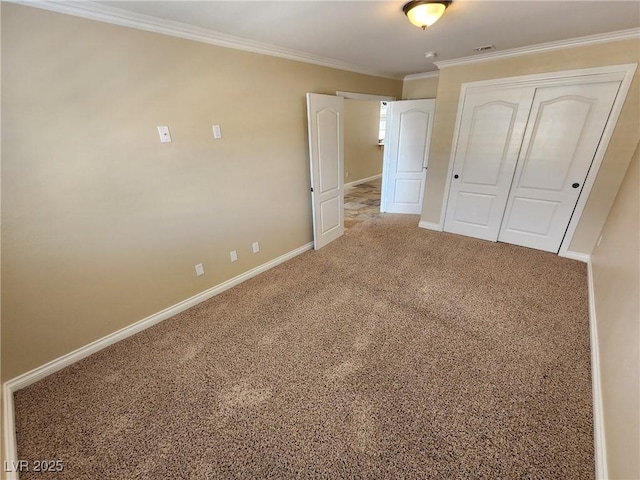 unfurnished bedroom with carpet floors, a closet, and ornamental molding