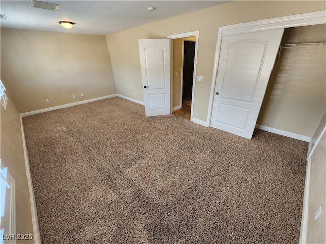 unfurnished bedroom featuring carpet floors and a closet