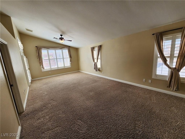 unfurnished room with ceiling fan, carpet, lofted ceiling, and a healthy amount of sunlight