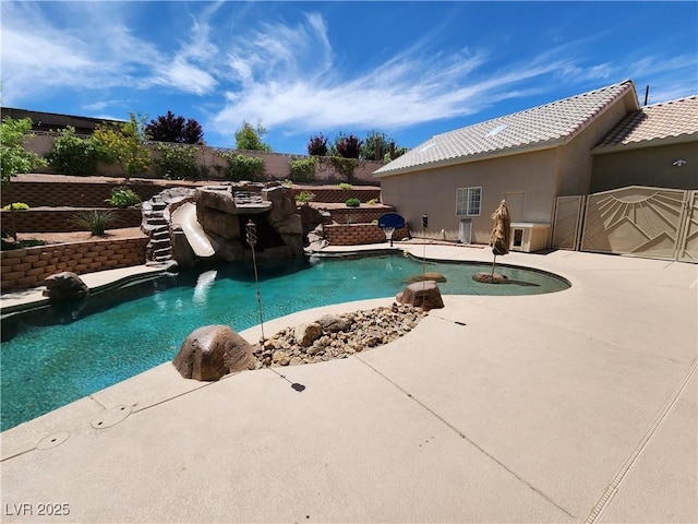 view of swimming pool with a patio area and a water slide