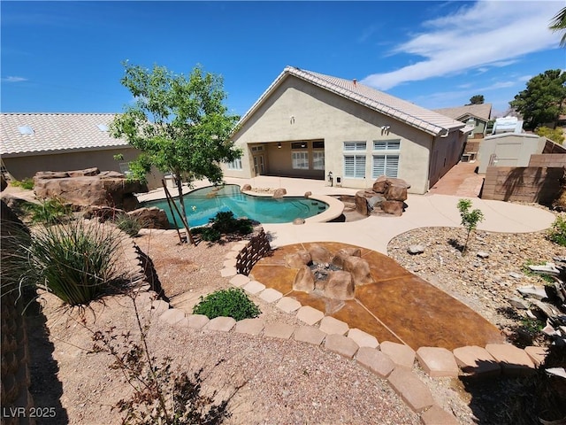 view of pool with a patio area and an outdoor fire pit