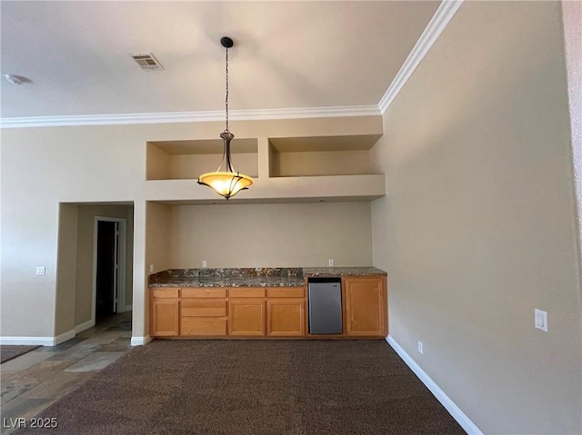 kitchen with dark carpet, hanging light fixtures, built in shelves, and crown molding