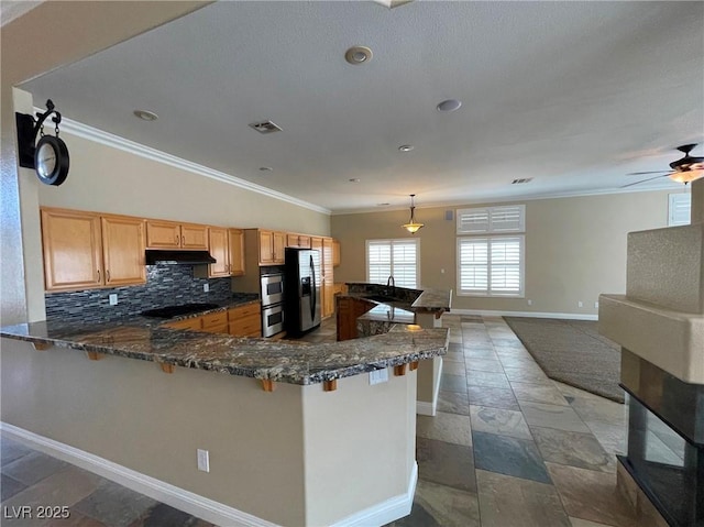 kitchen featuring kitchen peninsula, stainless steel appliances, tasteful backsplash, decorative light fixtures, and crown molding