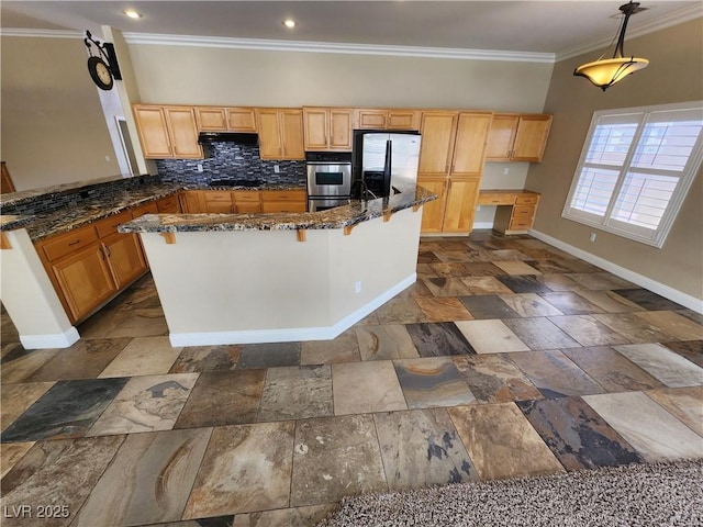 kitchen featuring decorative backsplash, appliances with stainless steel finishes, dark stone counters, and pendant lighting