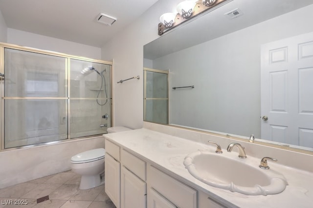 full bathroom with toilet, shower / bath combination with glass door, tile patterned floors, and vanity