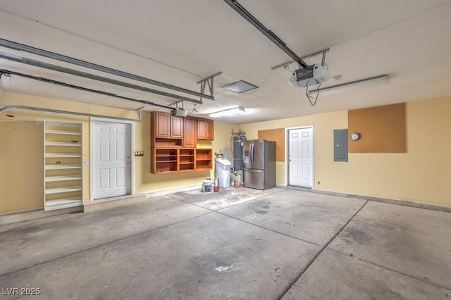 garage with stainless steel refrigerator with ice dispenser, electric panel, and a garage door opener