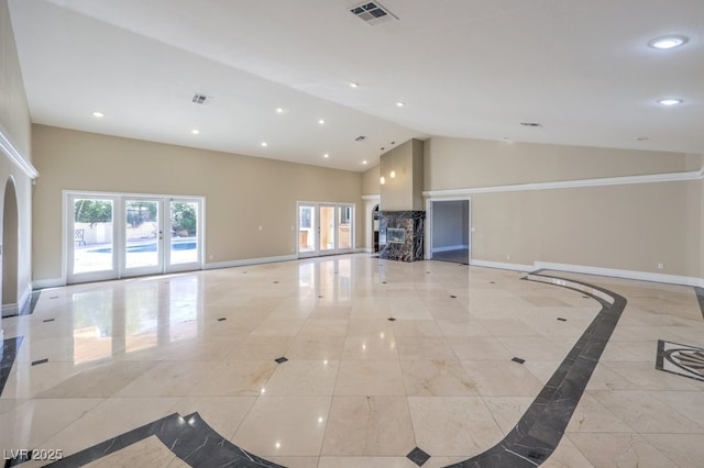 unfurnished living room featuring vaulted ceiling