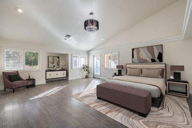 bedroom featuring hardwood / wood-style flooring, multiple windows, a notable chandelier, and vaulted ceiling