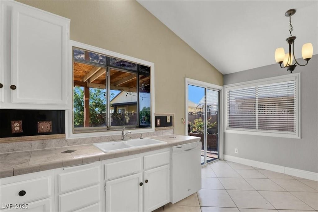 kitchen featuring dishwasher, white cabinetry, sink, hanging light fixtures, and tile counters