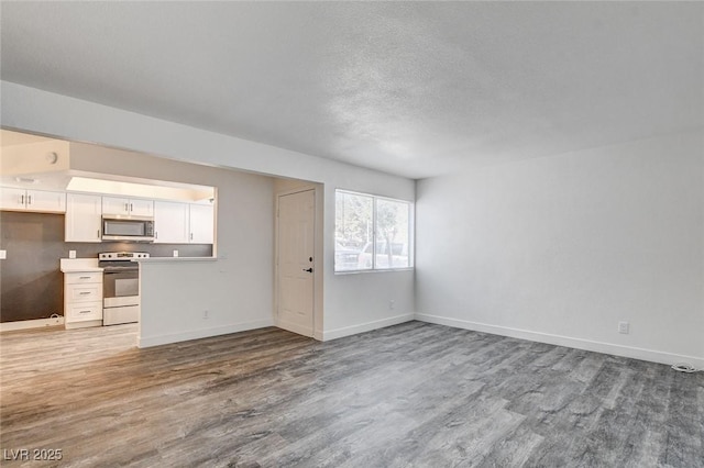 unfurnished living room with hardwood / wood-style flooring