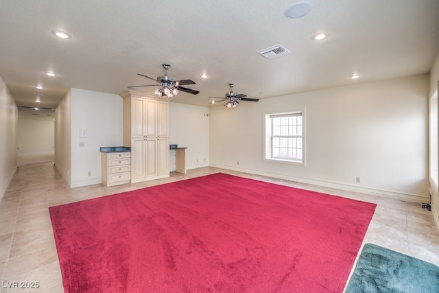 tiled spare room featuring ceiling fan