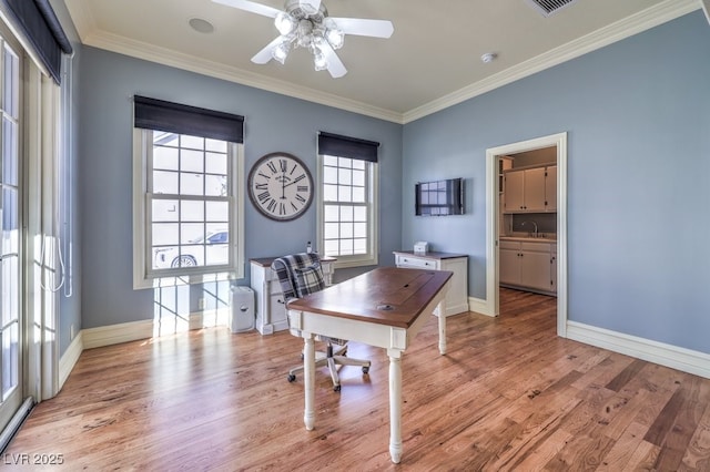 home office with light wood-type flooring, ceiling fan, crown molding, and sink