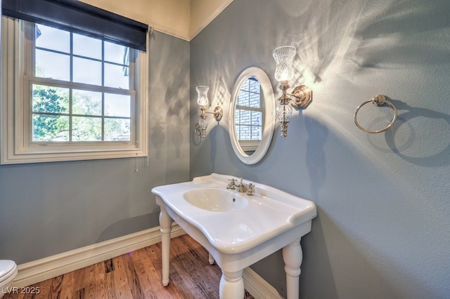 bathroom featuring sink, a wealth of natural light, toilet, and hardwood / wood-style floors