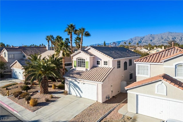 view of front of property featuring a mountain view and a garage