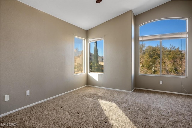 carpeted spare room featuring vaulted ceiling