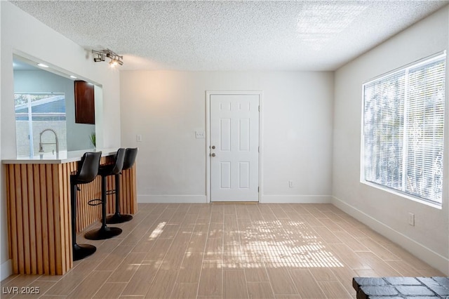 foyer featuring a textured ceiling and sink