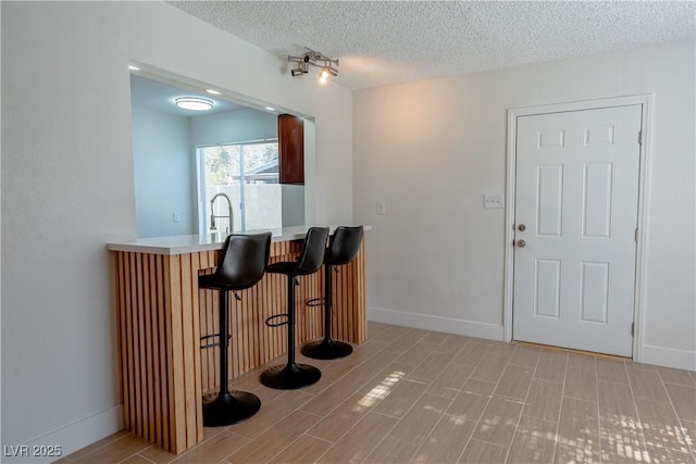 interior space with sink and a textured ceiling