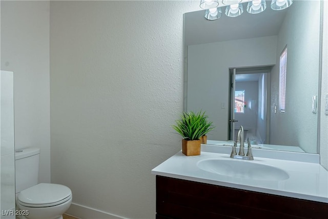 bathroom featuring toilet and vanity