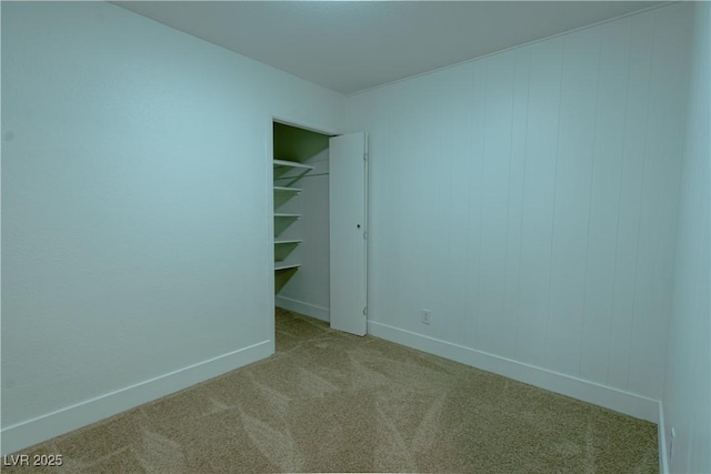 unfurnished bedroom featuring a closet and light colored carpet