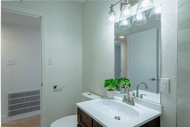 bathroom featuring toilet and vanity