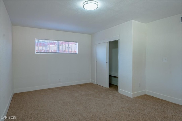 spare room with light colored carpet