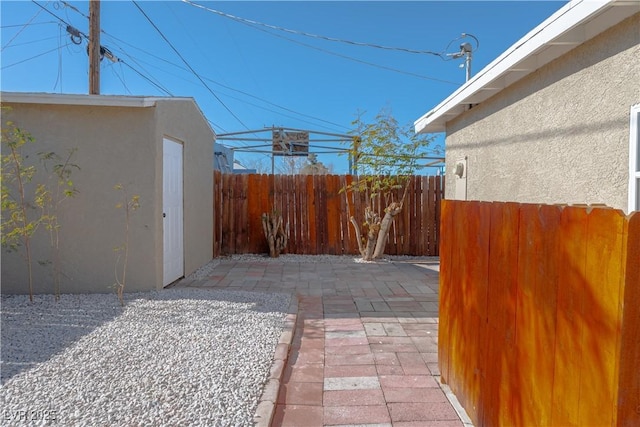 view of patio with a storage unit