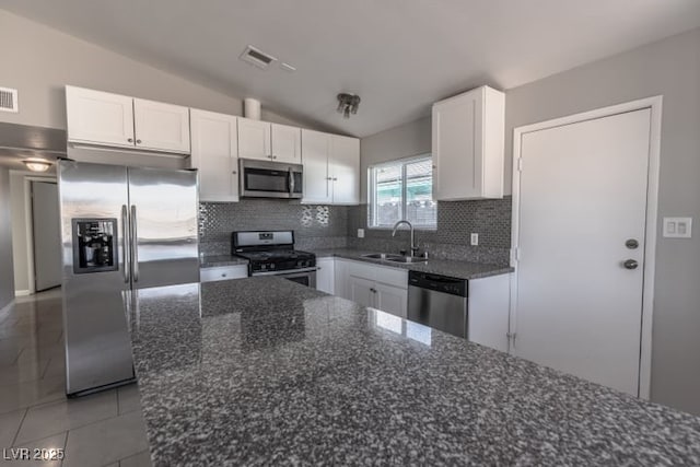 kitchen with stainless steel appliances, backsplash, white cabinetry, and sink