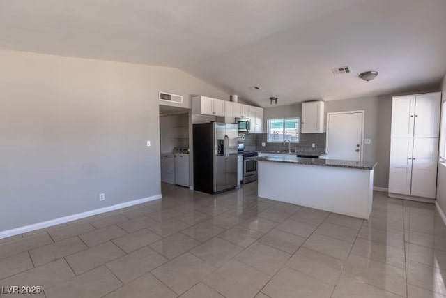 kitchen with sink, white cabinets, tasteful backsplash, and appliances with stainless steel finishes