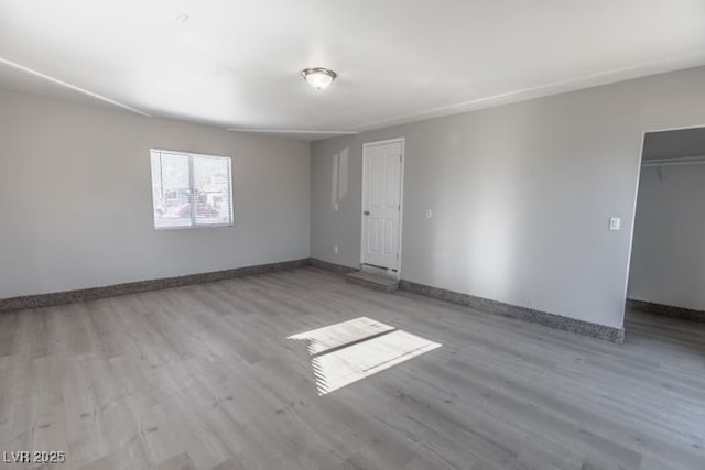 spare room with light hardwood / wood-style floors