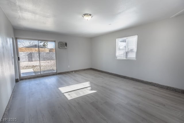 unfurnished room with dark hardwood / wood-style floors and a wealth of natural light