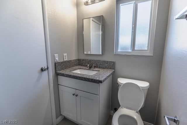 bathroom featuring toilet and vanity