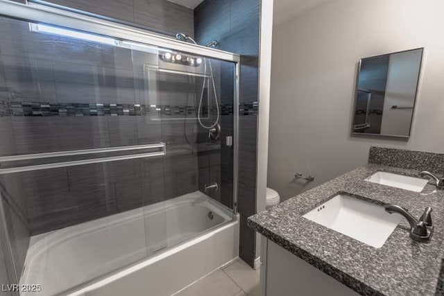 full bathroom with tile patterned floors, combined bath / shower with glass door, vanity, and toilet