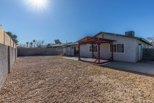 rear view of property with central AC and a patio area