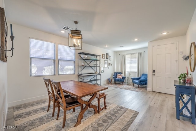 dining room featuring an inviting chandelier and light wood-type flooring