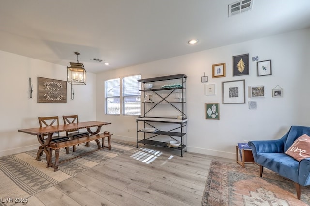 dining room featuring a notable chandelier and light hardwood / wood-style flooring